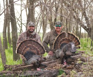 Nebraska turkey hunters shown with 2 turkeys.