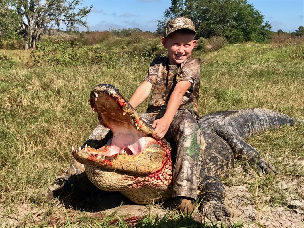 Child posing with gator from Florida, Private Land Hunt.