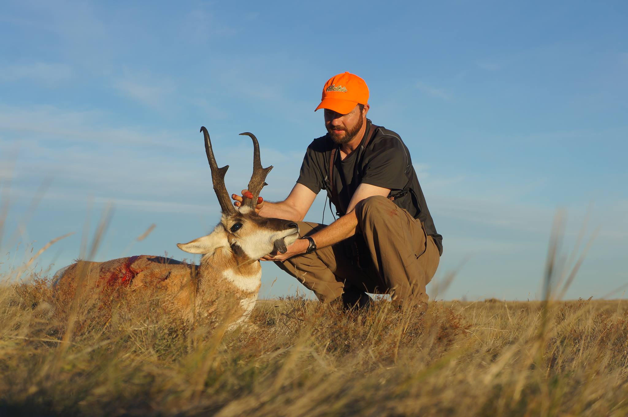 Hunter with antelope in Wyoming prairie.