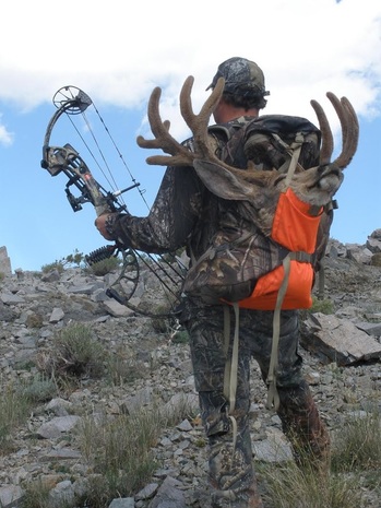 Hunter shown with mule deer harvest on a hunt in Santa Clara, Utah. 