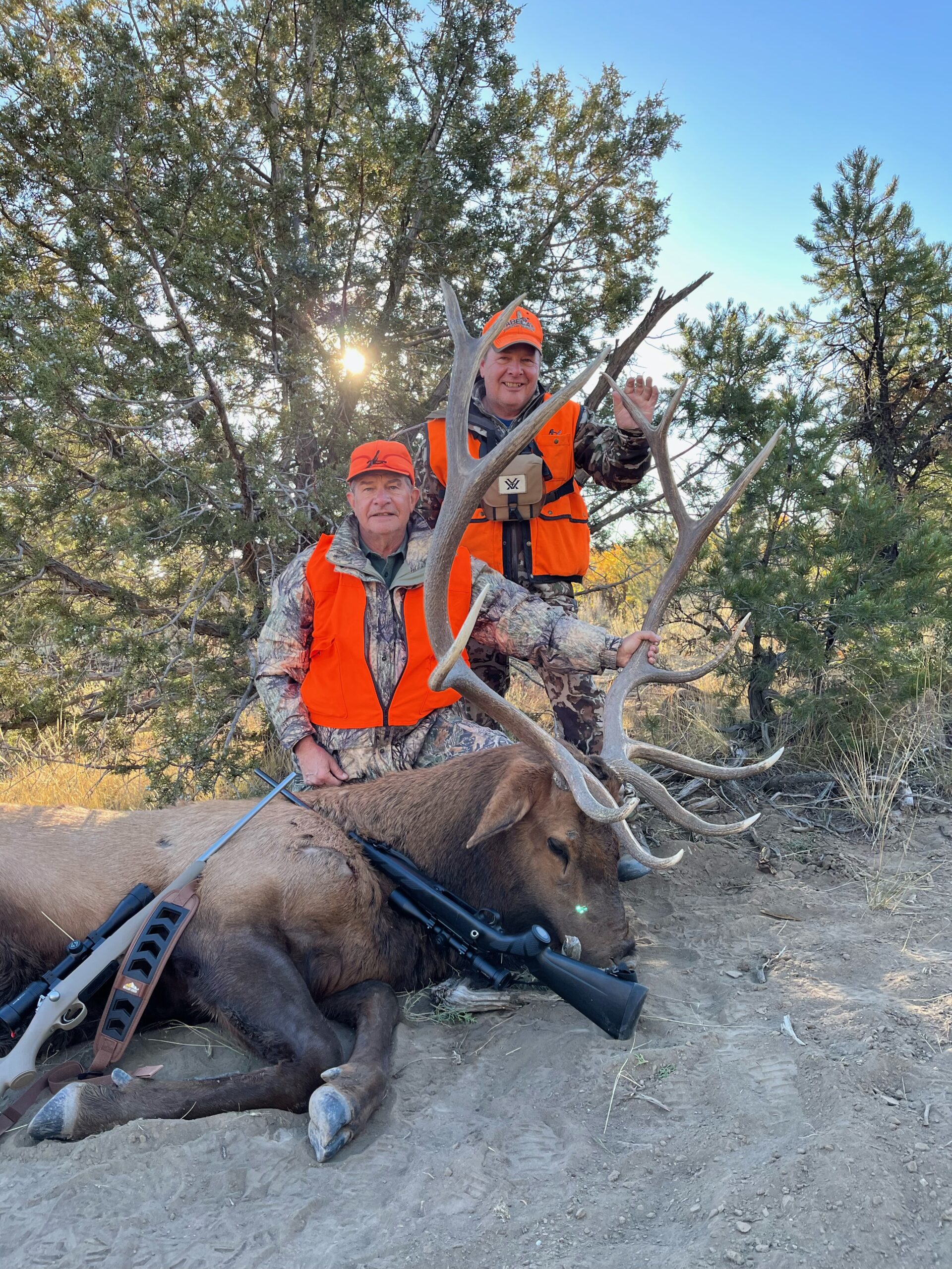 Two men hunting in colorado during elk season, with their trophy bull elk.<br />
