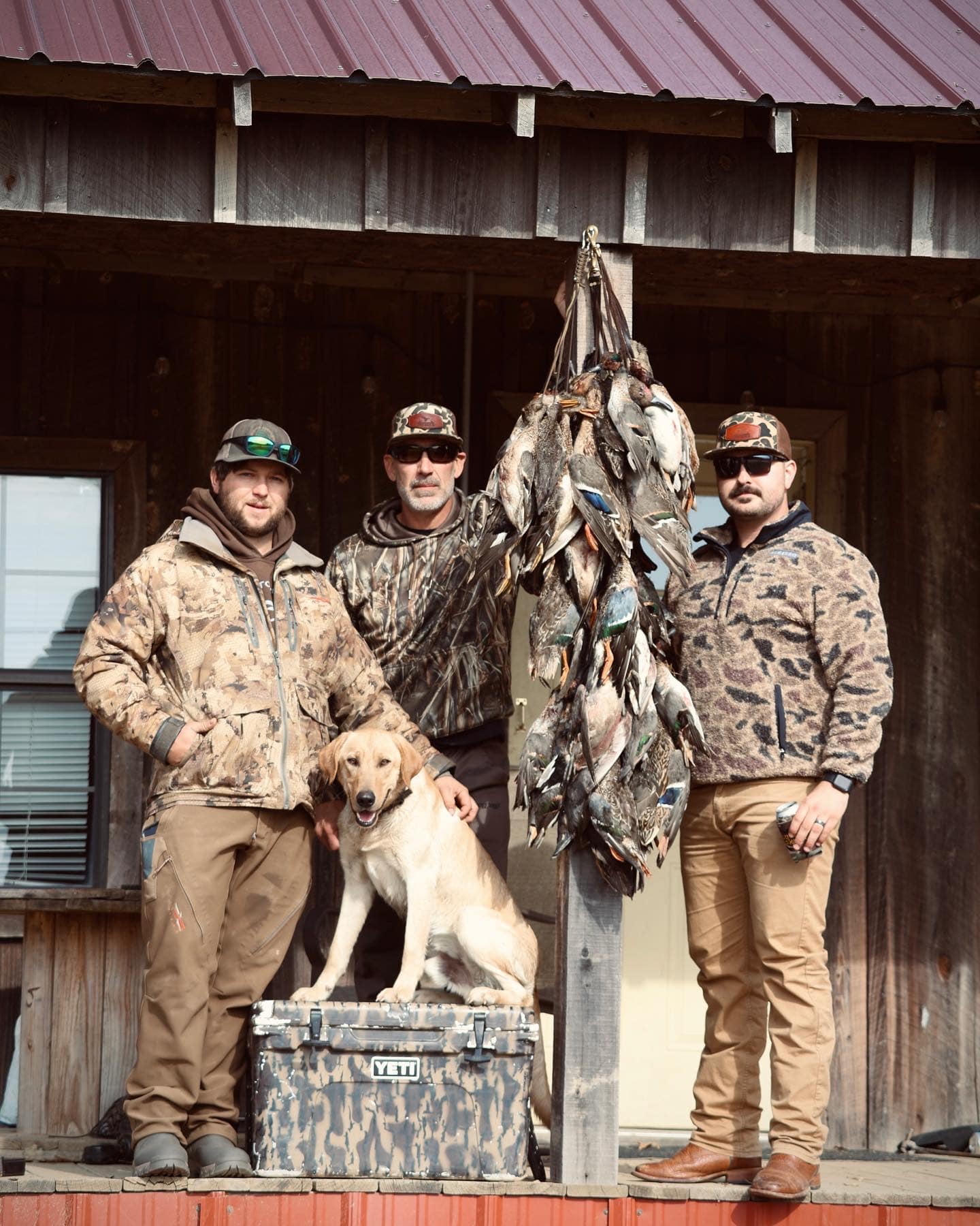 Arkansas hunting guide shown with dog and stringer full of ducks.